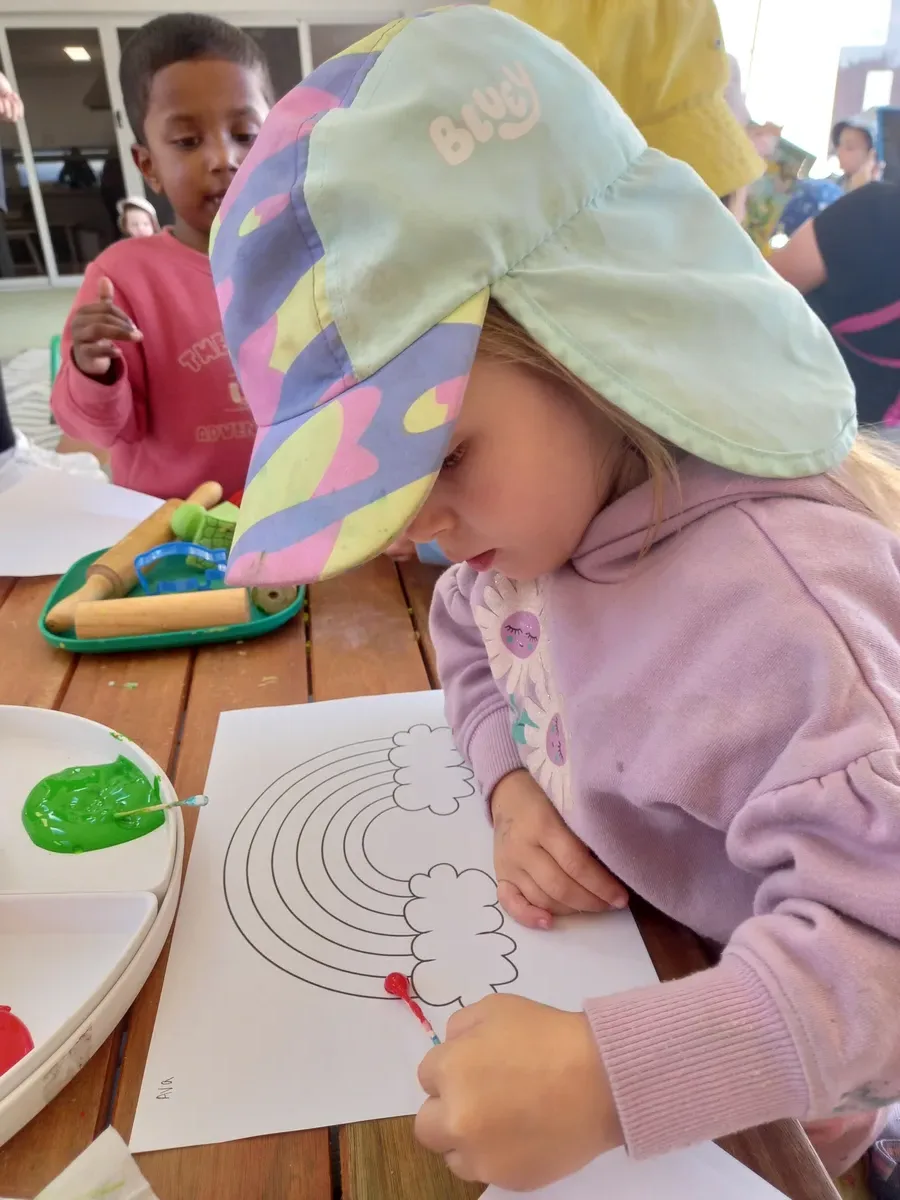 Toddlers engaged in play-based learning with natural materials at daycare